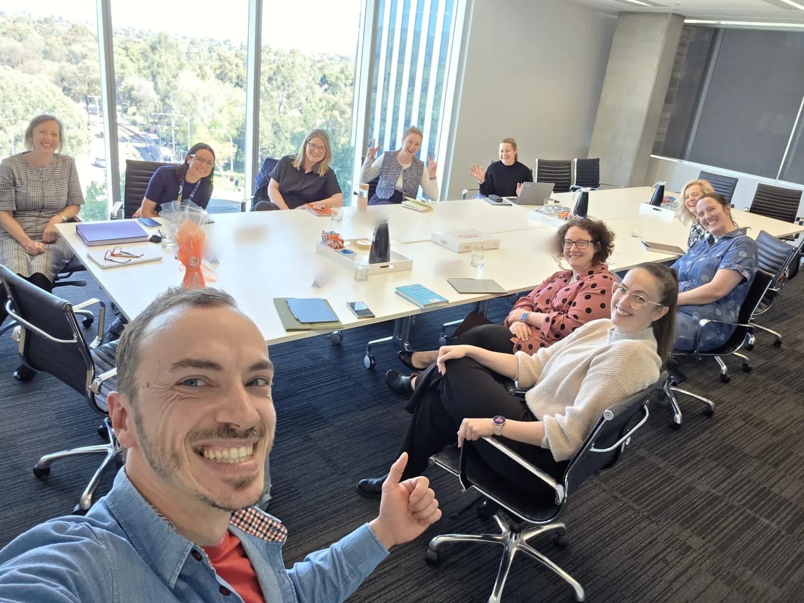 A leadership group working through an AI workshop session around a boardroom table in Adelaide